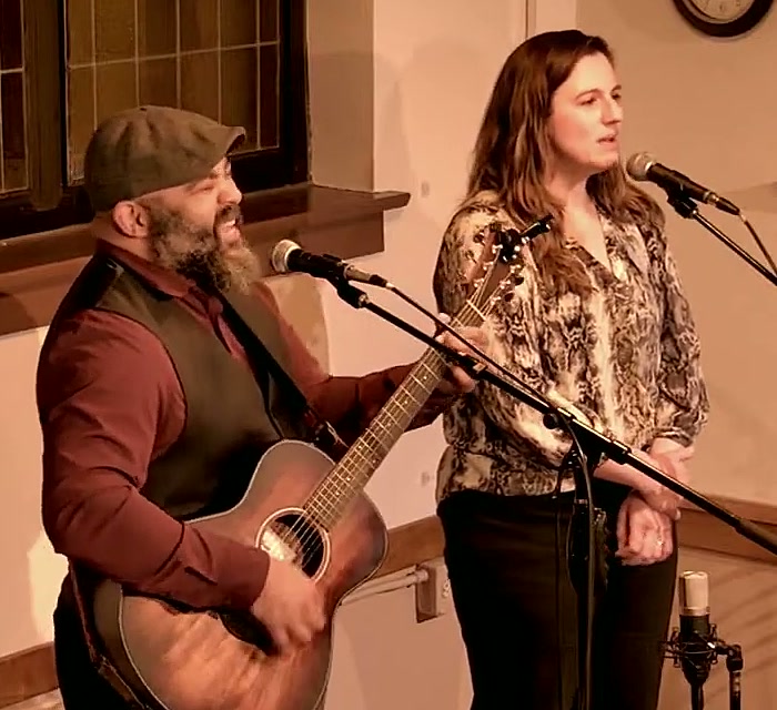 Port Town, George and Liz, singing together at their mics